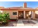 Charming home exterior with a red tile roof, a welcoming covered patio, and landscaped surroundings at 563 N Spanish Springs Dr, Chandler, AZ 85226