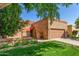 Charming single-story home with a well-maintained front yard and two-car garage at 563 N Spanish Springs Dr, Chandler, AZ 85226
