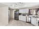Clean kitchen with stainless steel appliances and view into the hallway at 563 N Spanish Springs Dr, Chandler, AZ 85226