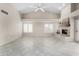 Bright living room with vaulted ceiling, ceiling fan, fireplace, and tile flooring at 563 N Spanish Springs Dr, Chandler, AZ 85226