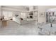 Bright, open-concept living room with vaulted ceilings, fireplace, and tile floors, seamlessly integrates the dining area at 563 N Spanish Springs Dr, Chandler, AZ 85226