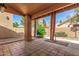 Inviting covered patio features a tiled floor and elegant curtains for outdoor relaxation at 563 N Spanish Springs Dr, Chandler, AZ 85226