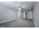 Spacious bedroom with neutral paint, carpet, ceiling fan, and closet with bright light at 6130 N 27Th Ave, Phoenix, AZ 85017