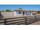 Charming home featuring a decorative dark wood fence, gravel landscaping, and a classic exterior paint scheme at 6130 N 27Th Ave, Phoenix, AZ 85017