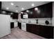 Kitchen featuring dark wood cabinets, granite countertops, modern appliances and recessed lighting at 6130 N 27Th Ave, Phoenix, AZ 85017