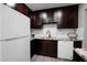 Kitchen featuring dark wood cabinets, granite countertops, modern appliances and recessed lighting at 6130 N 27Th Ave, Phoenix, AZ 85017