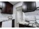 Updated kitchen showcasing dark cabinets, stainless steel appliances, and tiled backsplash at 6130 N 27Th Ave, Phoenix, AZ 85017