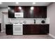 Updated kitchen features stainless steel appliances, dark cabinets, and granite countertops at 6130 N 27Th Ave, Phoenix, AZ 85017