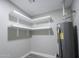 Utility room features a water heater, white shelves, gray walls and matching floor at 6130 N 27Th Ave, Phoenix, AZ 85017