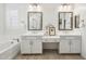 Bright bathroom with dual sinks, shower, tub and neutral decor at 634 E Deer Creek Rd, Phoenix, AZ 85048