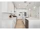 Contemporary kitchen featuring white cabinetry, a center island with seating, and stainless steel appliances at 634 E Deer Creek Rd, Phoenix, AZ 85048