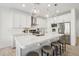 Modern kitchen with white cabinets, quartz countertops, pendant lighting, and stainless steel appliances at 634 E Deer Creek Rd, Phoenix, AZ 85048