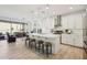 Open-concept kitchen featuring a large island, pendant lights, stainless steel appliances, and adjacent dining area at 634 E Deer Creek Rd, Phoenix, AZ 85048