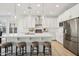 Bright kitchen featuring a large island, pendant lighting, white cabinets, and stainless steel appliances at 634 E Deer Creek Rd, Phoenix, AZ 85048