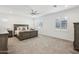 Spacious main bedroom featuring soft carpet, a ceiling fan, and neutral decor at 634 E Deer Creek Rd, Phoenix, AZ 85048
