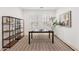 Modern office with a black desk, open shelving, and a patterned rug for a stylish workspace at 634 E Deer Creek Rd, Phoenix, AZ 85048
