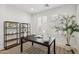 Modern office with a black desk, open shelving, and a patterned rug for a stylish workspace at 634 E Deer Creek Rd, Phoenix, AZ 85048