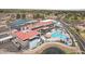 Striking aerial view of clubhouse with pool, tennis courts, and well-maintained landscaping in a gated community at 6341 S Cypress Point Dr, Chandler, AZ 85249