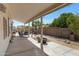 Covered patio with ample seating, stone landscaping, and privacy wall for relaxing outdoor enjoyment at 6341 S Cypress Point Dr, Chandler, AZ 85249