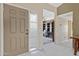Inviting entryway with a beige front door and sidelight, leading into a home office at 6341 S Cypress Point Dr, Chandler, AZ 85249