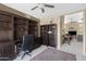 Home office with ceiling fan, built-in shelves, and a view of the living room at 6341 S Cypress Point Dr, Chandler, AZ 85249