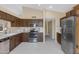 Spacious kitchen with stainless steel appliances, wood cabinets, and neutral countertops at 6341 S Cypress Point Dr, Chandler, AZ 85249