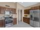 Updated kitchen featuring stainless steel appliances, wood cabinetry, and a spacious layout at 6341 S Cypress Point Dr, Chandler, AZ 85249