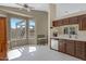 Bright kitchen with stainless appliances, wooden cabinets, and a breakfast nook at 6341 S Cypress Point Dr, Chandler, AZ 85249