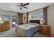This bright main bedroom has neutral walls, carpet, and access to a sliding glass door at 6341 S Cypress Point Dr, Chandler, AZ 85249