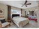 This bright main bedroom has neutral walls, carpet, and access to a closet and bathroom at 6341 S Cypress Point Dr, Chandler, AZ 85249