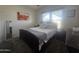 Cozy bedroom featuring a comfortable bed, dresser, nightstand, and carpeted floors at 650 N Hawes Rd # 3123, Mesa, AZ 85207