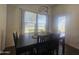 Dining room featuring a modern light fixture, large windows with views, and wood-look floors at 650 N Hawes Rd # 3123, Mesa, AZ 85207