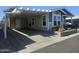 Single-story home featuring a covered parking, a garden, and a covered porch at 650 N Hawes Rd # 3123, Mesa, AZ 85207