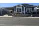 Charming single-story home featuring a cozy front porch, carport, and landscaped garden bed at 650 N Hawes Rd # 3123, Mesa, AZ 85207