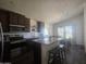 Kitchen with stainless steel appliances, granite countertops, an island with seating, and ample cabinet space at 650 N Hawes Rd # 3123, Mesa, AZ 85207