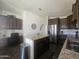 Kitchen boasts a granite island, stainless steel appliances, and dark wood cabinets with plenty of storage at 650 N Hawes Rd # 3123, Mesa, AZ 85207