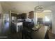 Modern kitchen featuring stainless steel appliances, granite countertops, and dark wood cabinetry at 650 N Hawes Rd # 3123, Mesa, AZ 85207
