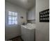 Practical laundry room with washer, dryer, and overhead cabinets at 650 N Hawes Rd # 3123, Mesa, AZ 85207