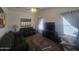 Cozy living room with comfortable sofas, a ceiling fan, and a large television for entertainment at 650 N Hawes Rd # 3123, Mesa, AZ 85207