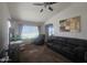 Inviting living room with a large sofa, recliner, ceiling fan, and decorative artwork at 650 N Hawes Rd # 3123, Mesa, AZ 85207