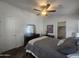 Cozy main bedroom featuring a ceiling fan, dresser with mirror, and access to a walk-in closet at 650 N Hawes Rd # 3123, Mesa, AZ 85207