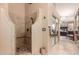 Modern bathroom featuring walk-in shower, tile surround, and a view into the bedroom at 7103 E Medina Ave, Mesa, AZ 85209