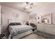 Charming bedroom with pink ceiling fan, white furniture, and a unique hanging chair at 7103 E Medina Ave, Mesa, AZ 85209