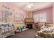Colorful bedroom with unique wall decor, plush toys, and a window letting in natural light at 7103 E Medina Ave, Mesa, AZ 85209