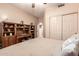 Bedroom featuring light-colored walls, ceiling fan, and closet storage space at 7103 E Medina Ave, Mesa, AZ 85209
