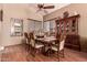 Well-lit dining room featuring a ceiling fan and a classic wooden dining set at 7103 E Medina Ave, Mesa, AZ 85209