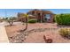 Well-manicured front yard with desert landscaping, rocks, and a charming palm tree enhancing curb appeal at 7103 E Medina Ave, Mesa, AZ 85209