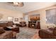 Comfortable living room with fireplace, ceiling fan, and multiple seating options at 7103 E Medina Ave, Mesa, AZ 85209