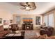 Cozy living room with a ceiling fan, entertainment center, and comfortable seating at 7103 E Medina Ave, Mesa, AZ 85209