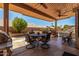 Charming covered patio with comfortable seating, ceiling fans, and a view of the pool at 7103 E Medina Ave, Mesa, AZ 85209
